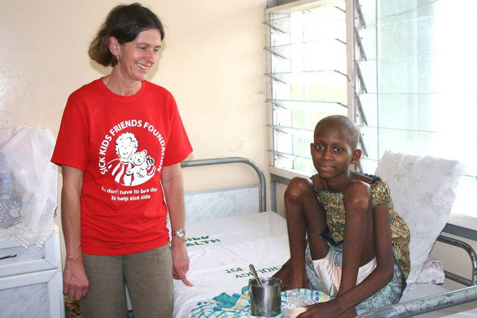 Dr Emma Johnson with a brave girl receiving treatment for osteosarcoma, 2011