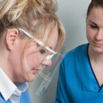 Young woman sitting on a stool watching. Dental hospital