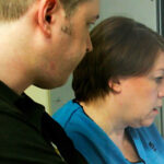 A radiologist and nurse looking at a monitor