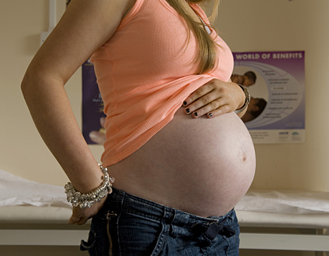 Photo of pregnant woman showing her baby bump.
