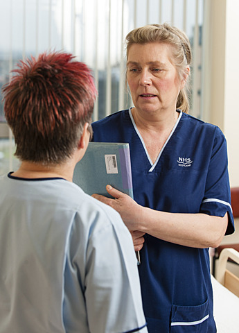 Two healthcare workers in discussion.