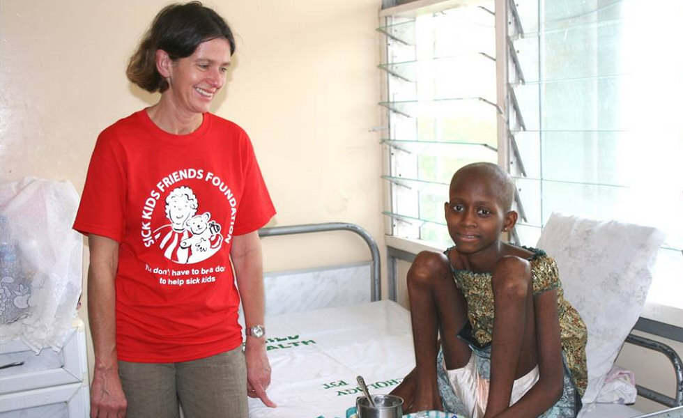 Dr Emma Johnson with a brave girl receiving treatment for osteosarcoma, 2011